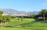 torrequebrada golf club looking down the fairway with views of the mountains in the background