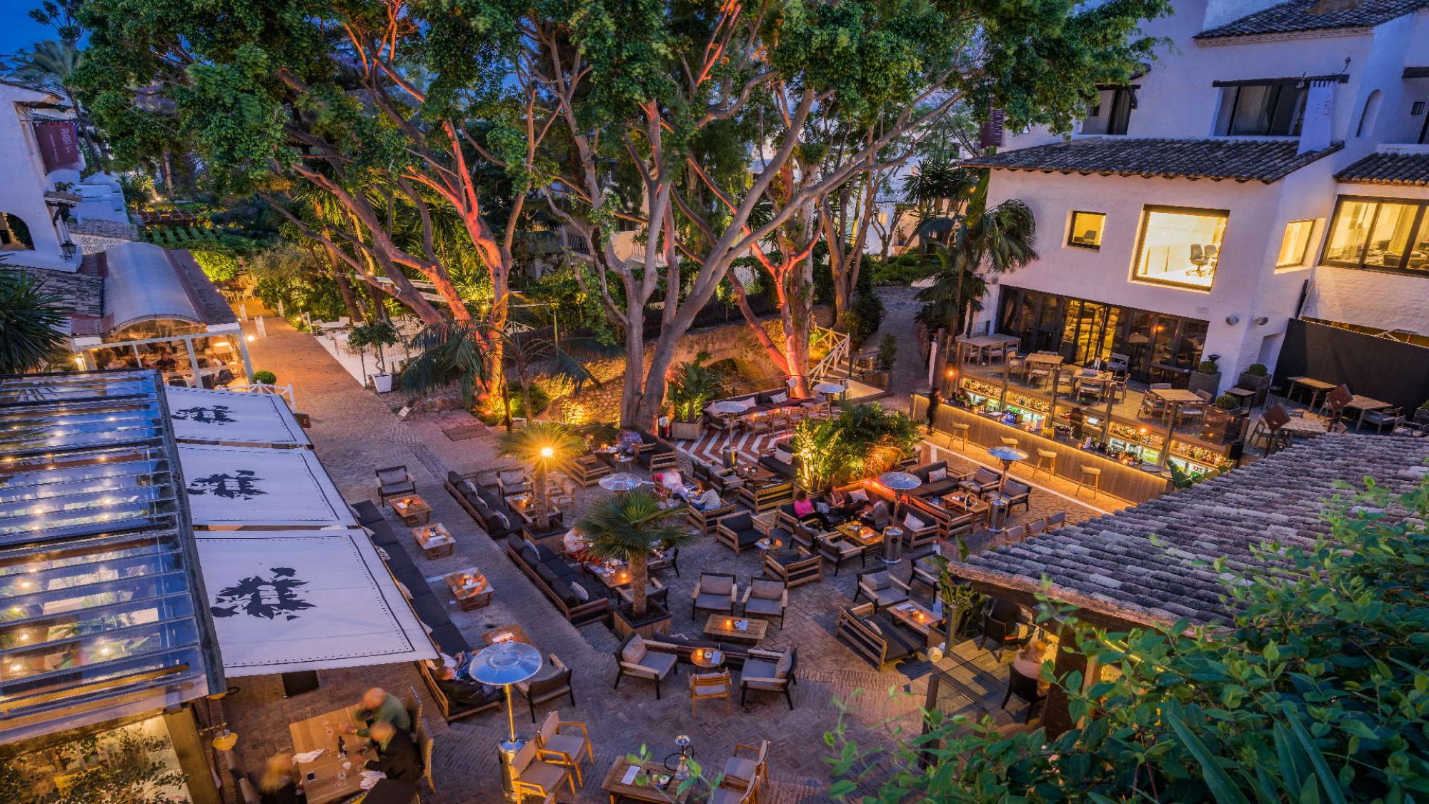 View Hotel Puente Romano's picturesque outdoor restaurant within magnificent Costa Del Sol.