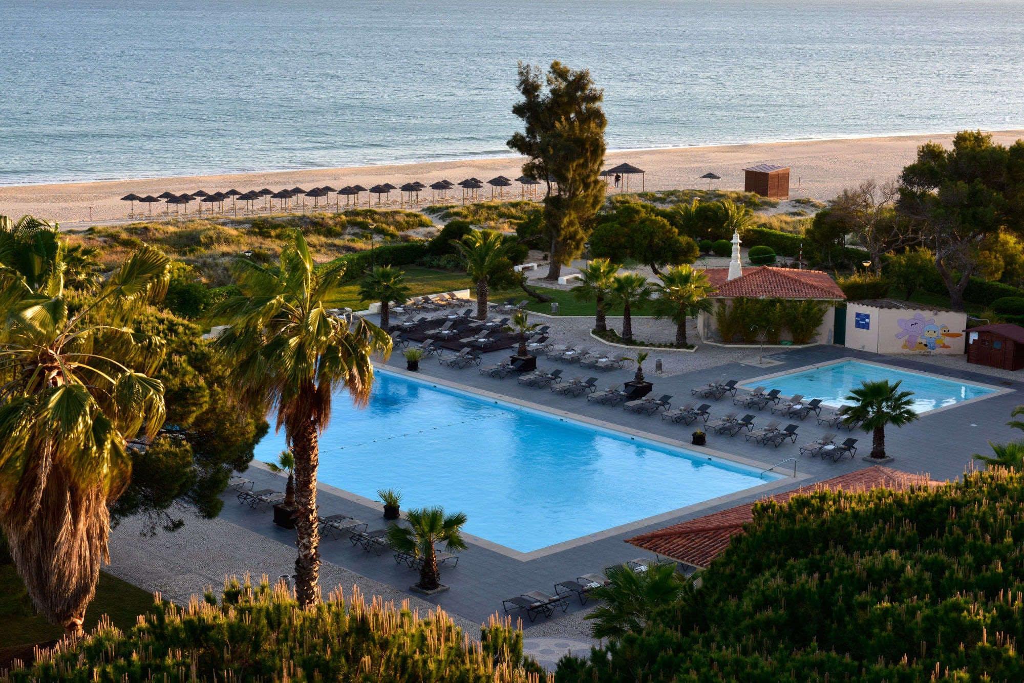 View Pestana Dom Joao II Hotel's picturesque outdoor pool within vibrant Algarve.