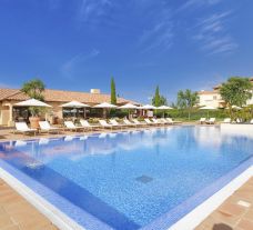 The Monte Rei Golf  Country Club's impressive outdoor pool situated in breathtaking Algarve.