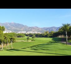 torrequebrada golf club looking down the fairway with views of the mountains in the background