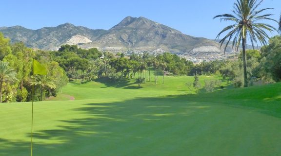 torrequebrada golf club looking down the fairway with views of the mountains in the background